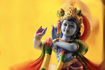 Beautiful Indian God Krishna or Govinda on Yellow Background.
