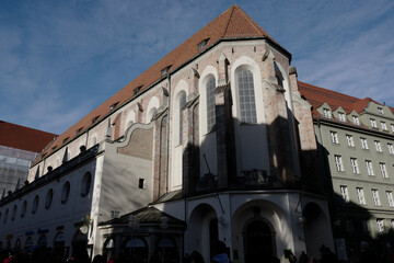 Historic Architecture of an Old Church Surrounded by Modern Buildings under a Clear Blue Sky