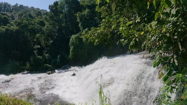 The Pha Dok Seaw Waterfall in Chiang Mai, Thailand, offers a serene view, with lush forest and flowing water enhancing the peaceful atmosphere.