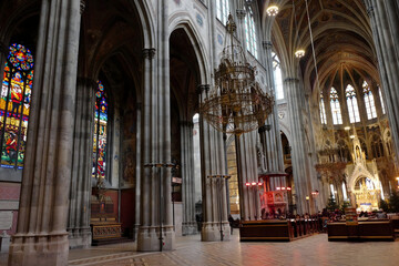 Fototapeta premium Stunning Interior Architecture of Historic Cathedral with Colorful Stained Glass Windows and Majestic Lighting