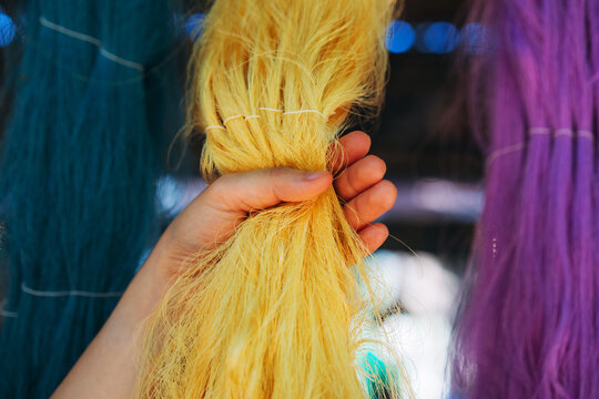 Close-Up Hand Touch of Natural colorful silk threads and dyeing with raw materials, traditional Thai sericulture in the countryside.