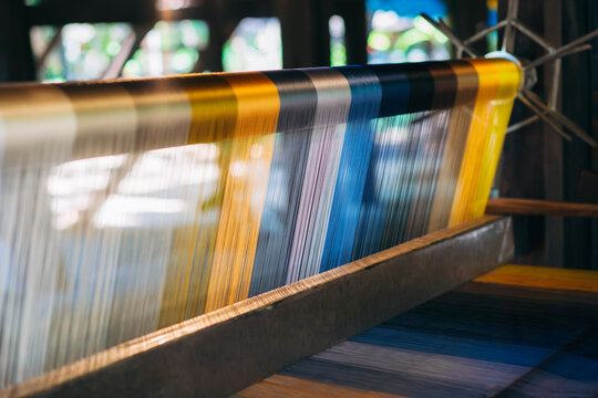 Silk thread from weaving machine traditional craft, a vibrant tapestry of color.