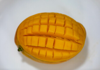 Ripe rosa mango isolated on uniform background. Brazilian fruit and food