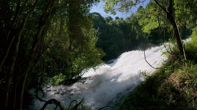 The Pha Dok Seaw Waterfall in Chiang Mai, Thailand, offers a serene view, with lush forest and flowing water enhancing the peaceful atmosphere.