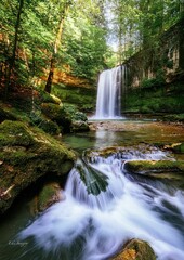 A-generated serene waterfall cascades into a clear pool surrounded by lush green forest