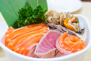 Mixed sashimi on ice in white bowl. Sashimi Salmon Tuna Prawn and Surf Calm set