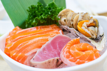 Mixed sashimi on ice in white bowl. Sashimi Salmon Tuna Prawn and Surf Calm set