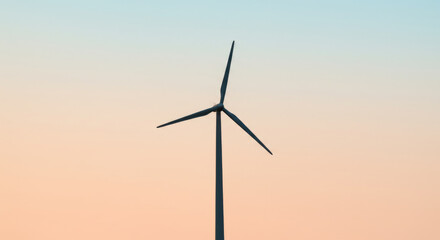 Obraz premium Wind turbine against a tranquil sunset sky