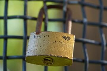 
a padlock attached to the railing of a bridge as a sign of lasting love