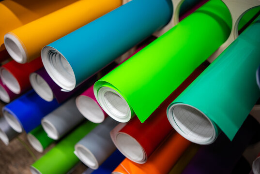 Rolls of self-adhesive film in different colors on the store shelf.Vinyl self-adhesive film for pasting cars and advertisements.