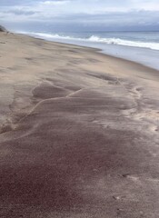 Abstract sand art frame at Atlantic beach with iron rich/volcanic sand
