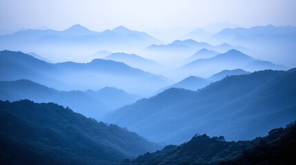 Fototapeta premium Misty mountain ranges in a pale blue hue.