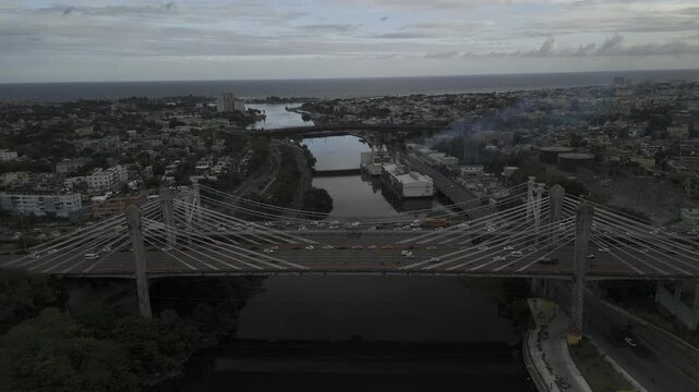 Drone lowers on north side of Juan Pablo Duarte Bridge, facing the Caribbean Sea to the south at the end of the Ozama River in Santo Domingo, Dominican Republic