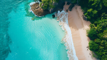 Aerial view of a tropical beach with turquoise water and lush green vegetation on the coastline