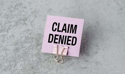 A pink card with the word Claim Denied written on it