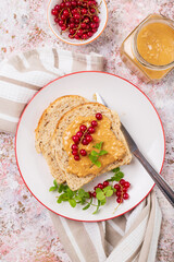 Whole grain sandwich with peanut butter and red currant top view