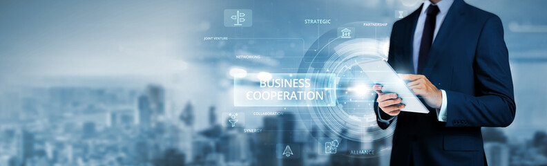 Business Cooperation, businessman using tablet analyzing partnership data and collaborative network. Strategic alliances, cross-industry synergies, global business development strategies.