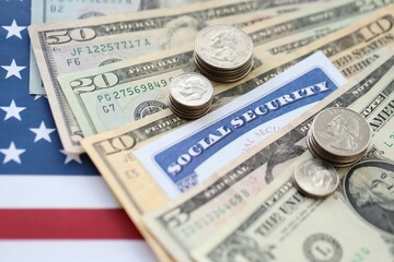 Fototapeta premium American US dollars money bills, social security number card and on American flag