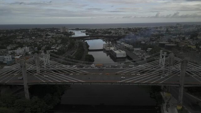 Drone flies south over the Juan Pablo Duarte Bridge toward the Matias Ramon Mella Bridge over the Ozama River in Santo Domingo, Dominican Republic