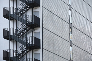 Modern building with black metal fire escape and glass brick wall exterior
