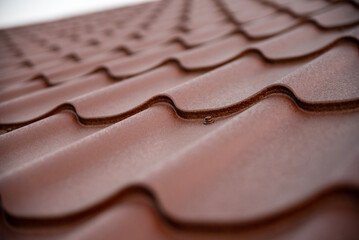 Durable metal roof tiles with textured finish and protective wave design..
