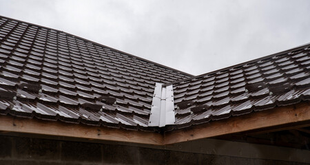 Brown metal roof with internal joint © Sergey