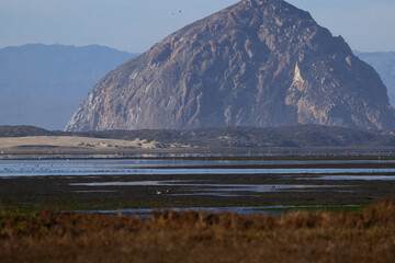 Morro Rock in distinctive view from overlook of Morro Bay in Sweet Springs Nature Preserve in Southern California