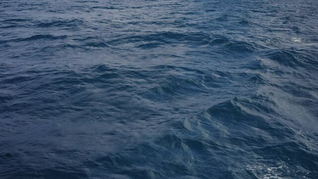 Slow motion side view from boat in Indian ocean sailing between Seychelles islands in daytime