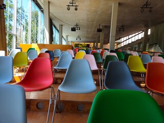 A lot of colorful chairs. Multi colored chairs arranged in the room. 