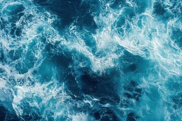Aerial view of ocean water with white wave formations