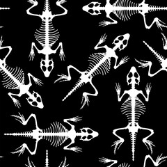 Seamless Pattern for Halloween. Skeletal system of animals. White lizard bone structure isolated on a black background. 
