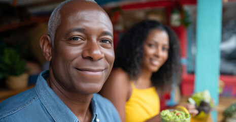 Fototapeta premium Mature african male enjoying meal with young african female at a cafe