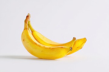Two ripe yellow bananas curved in a gentle arc against a clean white background.