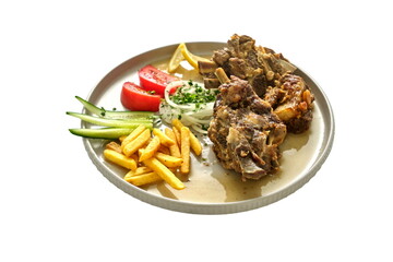 Juicy fried meat in sauce on a plate with French fries, salad, and slices of lemon, tomato, and cucumber — presented on a white background.