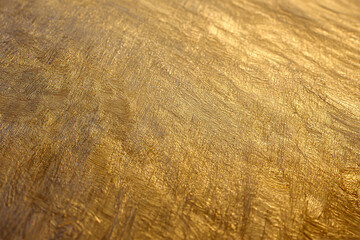 Fototapeta premium Golden Texture: An abstract and elegant macro photograph reveals the intricate textures and patterns of gold. The interplay of light and shadow enhances the metallic sheen.