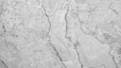 A white marble wall with a crack in it. The crack is long and jagged, giving the wall a rough and uneven appearance