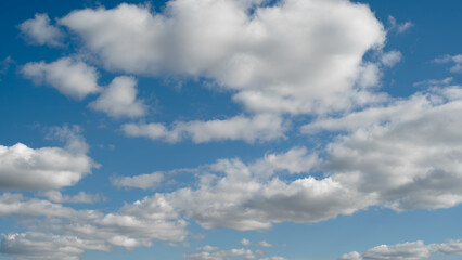 heaven sky is blue with a few clouds scattered throughout. The clouds are white and fluffy, giving the sky a peaceful and serene