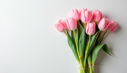 Fototapeta premium Bouquet of pink tulips with green stems on white background