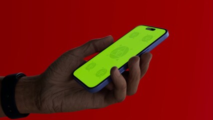 Asian old male using smartphone with a blank green screen. Mobile app video mockup. Vertical phone orientation