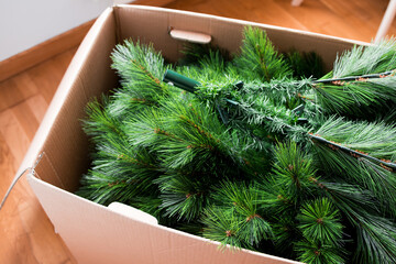 Cardboard box with disassembled artificial Christmas tree