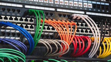 multi-colored fiber optic wires inserted into electronic switching unit, industrial internet...