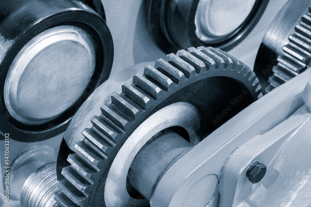 Poster a close up of a gear with a silver and black color. the gear is part of a machine and is in the midd