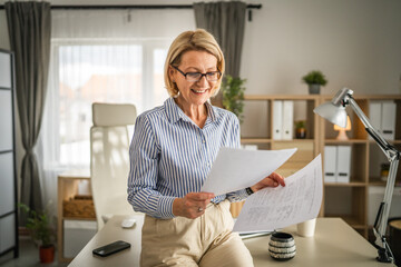 mature woman read contract document paper at office happy smile