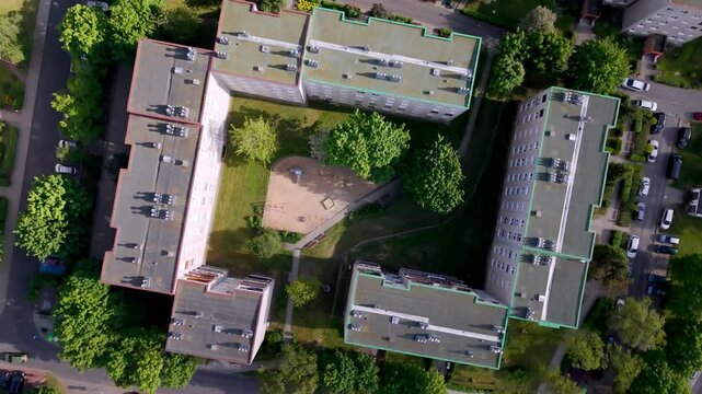 Drone footage of a residential neighborhood featuring modern homes, green spaces, and organized streets. Aerial views highlight urban planning, community living, and harmonious architecture.
