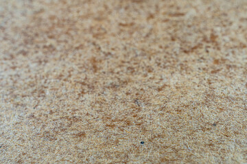 Close-up image of high-quality textured wall covering, featuring warm earthy brown colors and a fine, uniform texture suggesting durability and potential eco-friendliness for insulation or soundproof