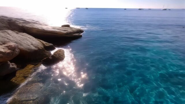 Calm turquoise sea with rocky shores and distant boats, creating a serene coastal scene