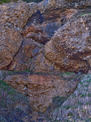 Natural rock formation showcasing water flow in a serene landscape during daylight hours