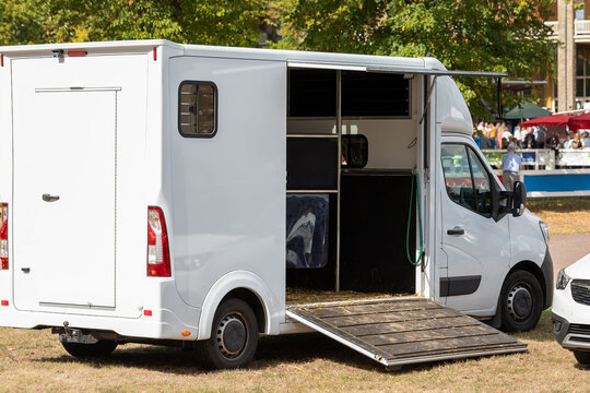 Horse box cargo trailer transport with open tailgate with hay and manure and horse transportation van at farm or ranch. Horsebox carriage lorry animal livestock tranport haulage