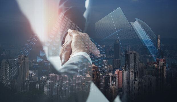 Business, finance and investment background. Business handshake, businessman shaking hand double exposure with office buildings and smart city, successful deal of global business