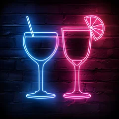 Neon cocktail glasses sign on brick wall. Glowing blue and pink drinks. Nightclub bar decoration. Party atmosphere concept for New Year's Eve, Valentine's Day, or happy hour